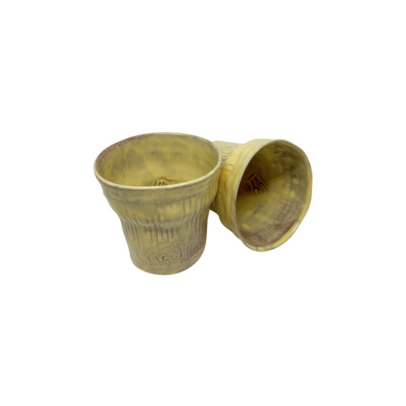 Biri devrik duran iki adet ucuk sari seramik bardak_Two pale yellow ceramic cups