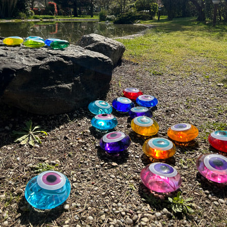 Goletli bahcede rengarenk cam nazarliklar_Colorful glass evil eye beads in the garden with pond