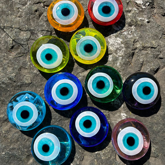 Kayanin ustunde on bir renk cam nazar boncugu_Different colors of evil eye beads on the rock