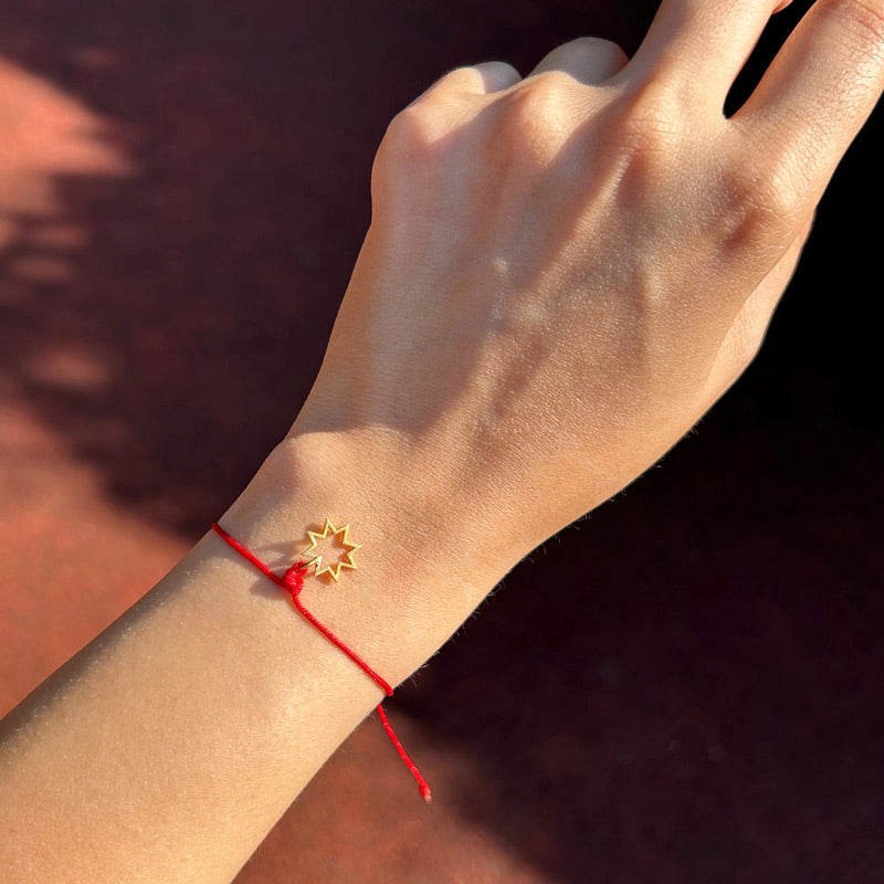Kolda yildiz motifli kirmizi ipli bileklik_Red string bracelet with star motif on the arm under the sun