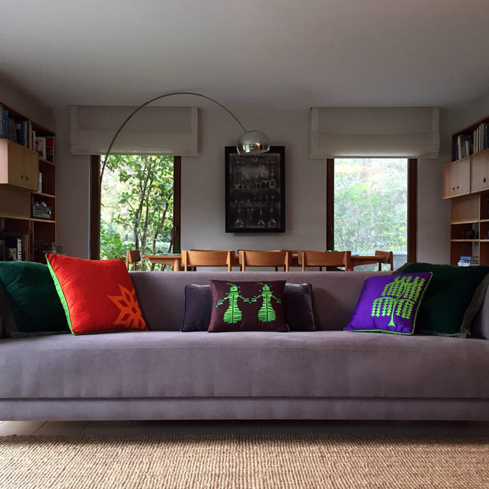 Salondaki gri uzun kanepede rengarenk kadife ve ipek yastiklar_Colorful velvet and patterned silk pillows on the gray long sofa in the living room